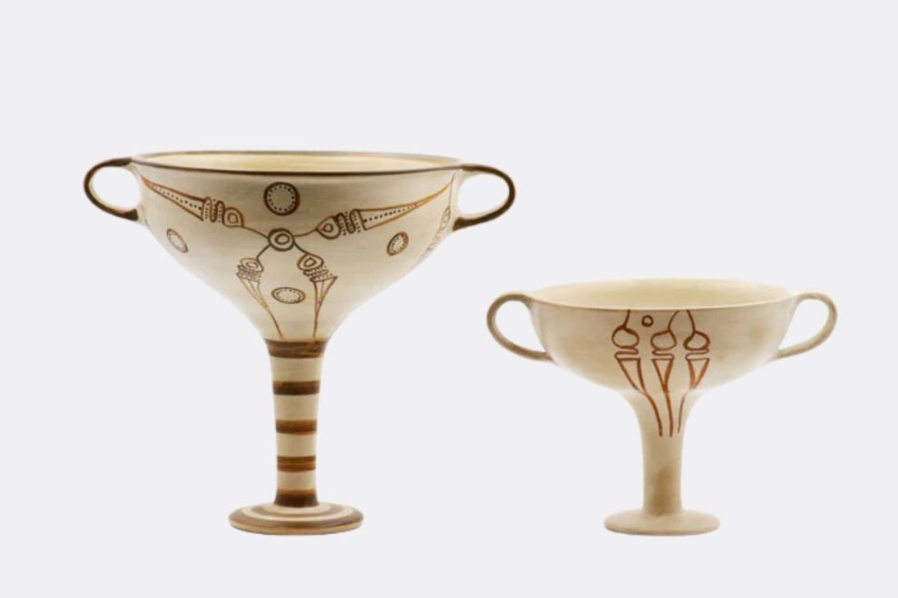 Two Mycenaean kylixes with decorative linear and floral motifs.