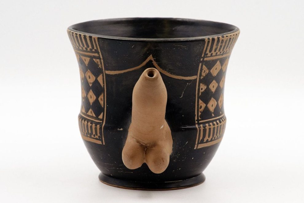 Ancient Greek kantharos with a phallic spout, showcasing erotic symbolism in classical pottery design.