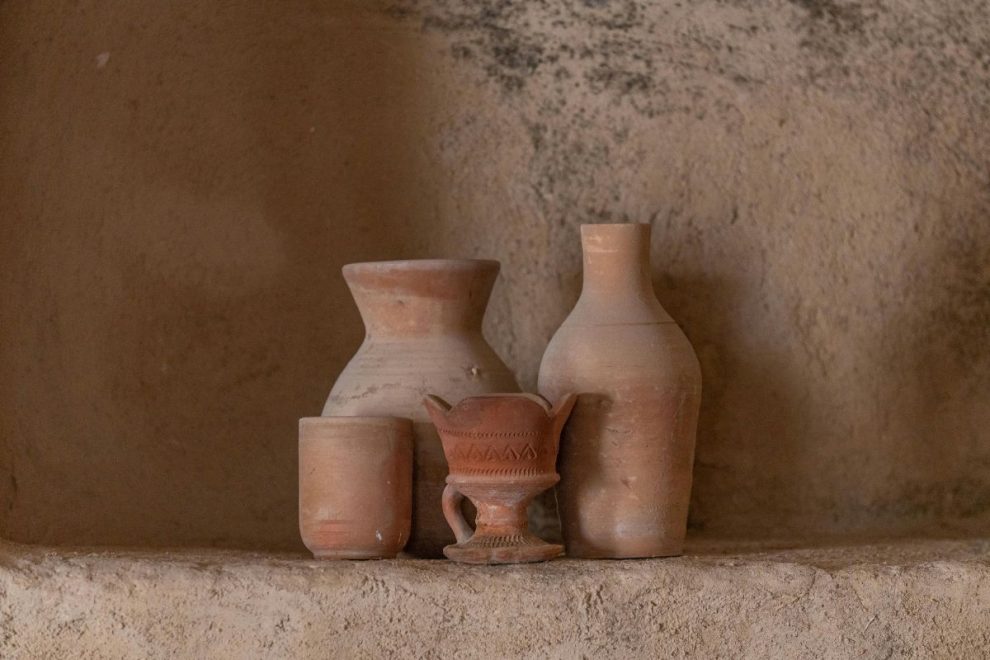 clay pottery vessels displayed on a rustic surface in traditional style 