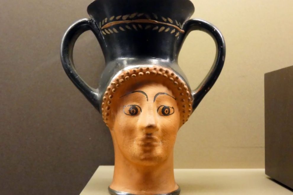 Ancient Greek pottery vessel with human face design, an early influence on modern Greek pottery styles. 
