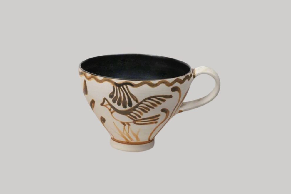Ancient Greek pottery mug with bird motif in painted design.