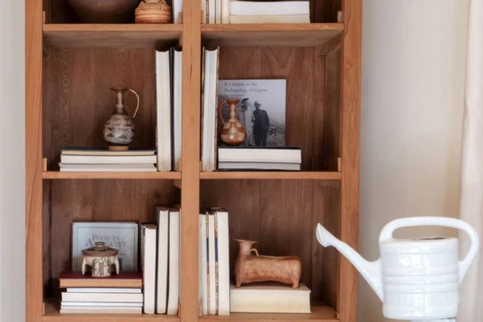 Bookshelf display with Cypriot pottery and archaeology books.