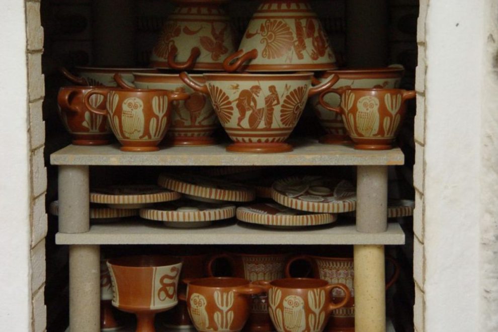 Modern kiln filled with ancient Greek pottery reproductions during the firing process.