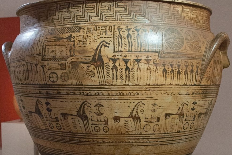 Attic Late geometric krater. On the main zone is depicted ekfora (carrying out of the body to the grave) of the deceased on a carriage, around which are women mourners and men withs swords. From the Dipylon. By the Hirschfeld Painter, 750-735 BC. National Archaeological Museum of Athens
