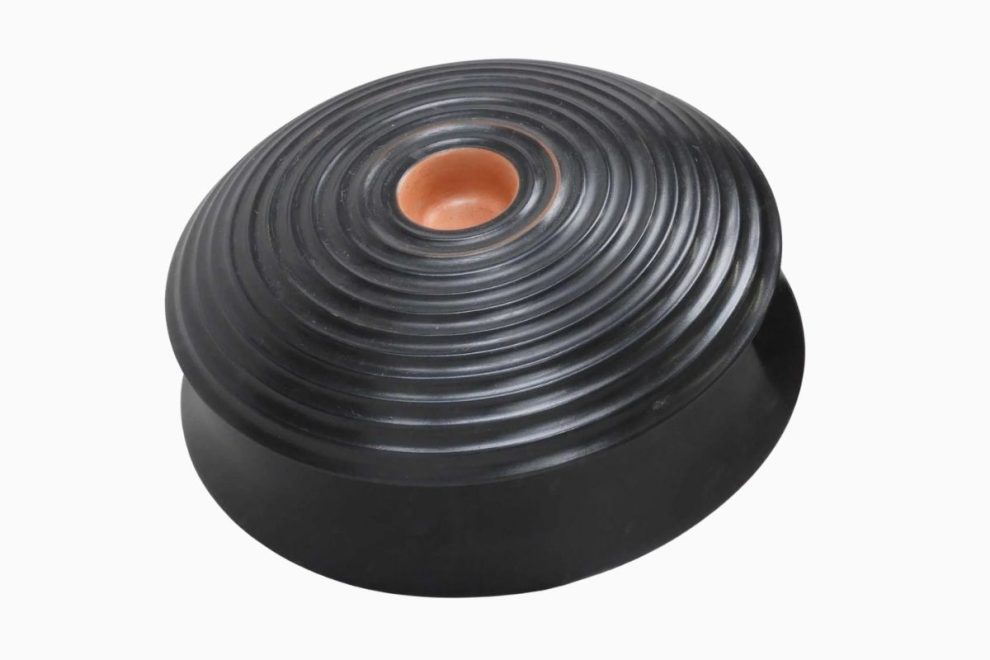 Ribbed black ancient Greek phiale with central indentation used for libation offerings in religious rituals.